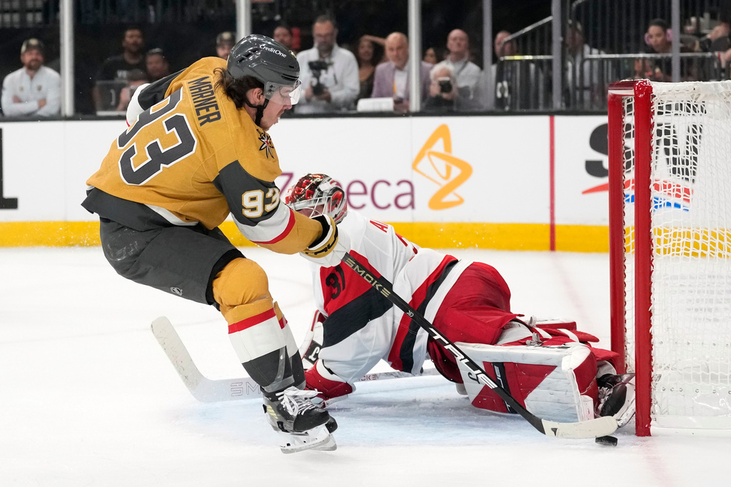 Carolina Hurricanes goaltender Frederik Andersen, right, stops a shot by Vegas Golden Knights right wing Mitch Marner during the second period in Game 3 of the NHL hockey Stanley Cup Final series Saturday, June 6, 2026, in Las Vegas. (AP Photo/John Locher)