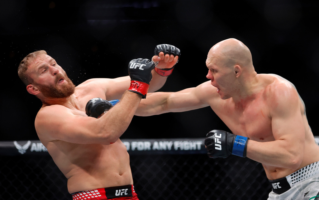Jan Blachowicz, left, takes a punch from Bogdan Guskov, right, in a light heavyweight mixed martial arts bout during UFC 323, Saturday, Dec. 6, 2025, in Las Vegas. (Steve Marcus/Las Vegas Sun via AP)