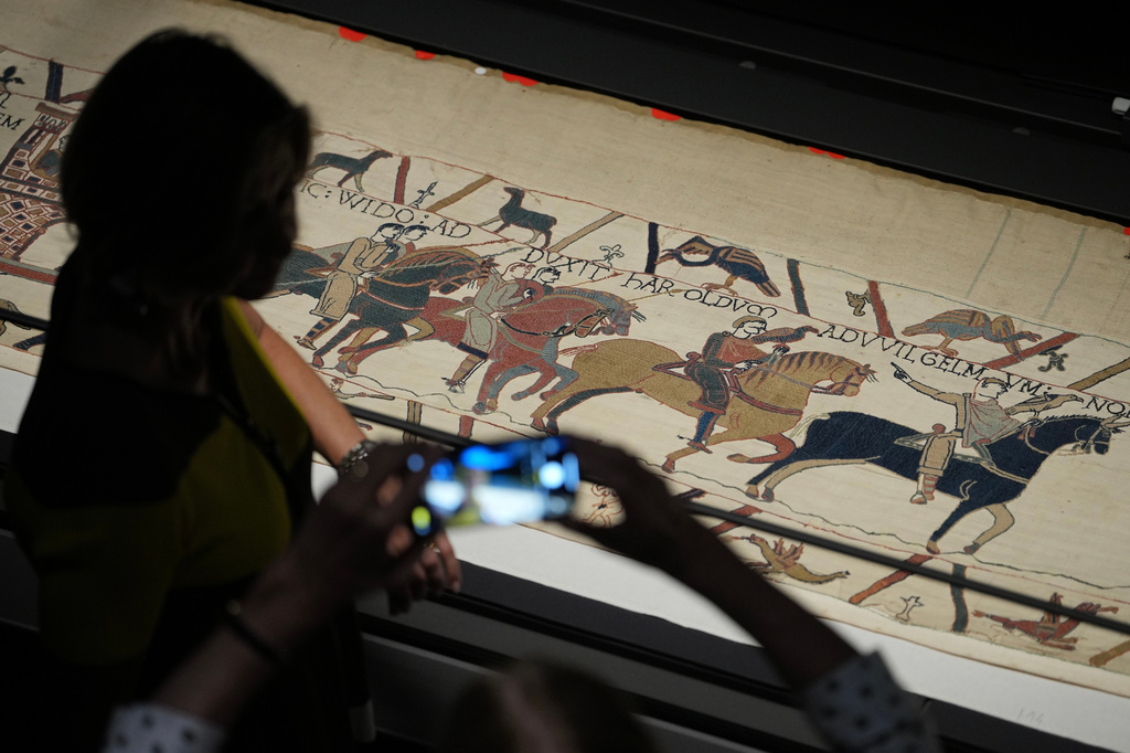 The 70-meter-long Bayeux Tapestry is displayed during a press preview at the British Museum in London after returning to England, following a historic agreement between the UK and France, Monday, Sept. 7, 2026. (AP Photo/Kin Cheung)