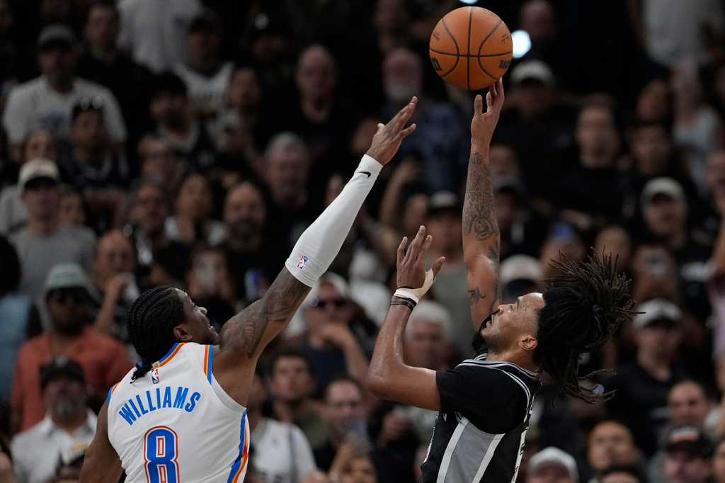 San Antonio Spurs guard Stephon Castle (5) shoots over Oklahoma City Thunder guard Jalen Williams (8) in the second half of Game 6 in the Western Conference finals NBA basketball playoffs series, Thursday, May 28, 2026, in San Antonio. (AP Photo/David J. Phillip)