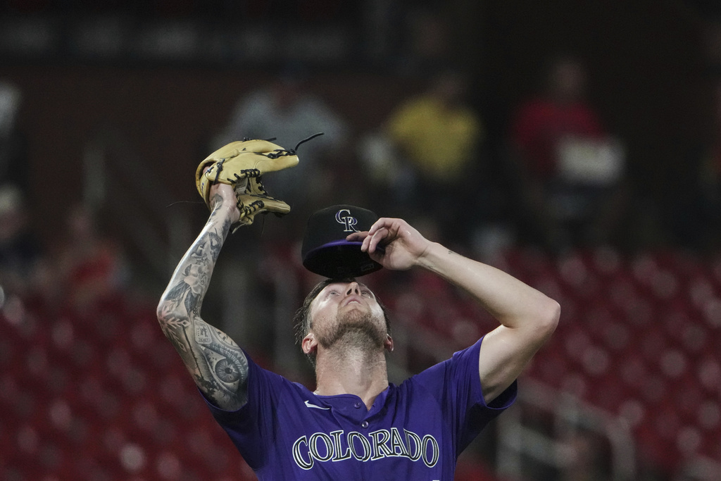 Colorado Rockies starting pitcher Kyle Freeland adjusts hit cap during the seventh inning of a baseball game against the St. Louis Cardinals Tuesday, Aug. 12, 2025, in St. Louis. (AP Photo/Jeff Roberson)