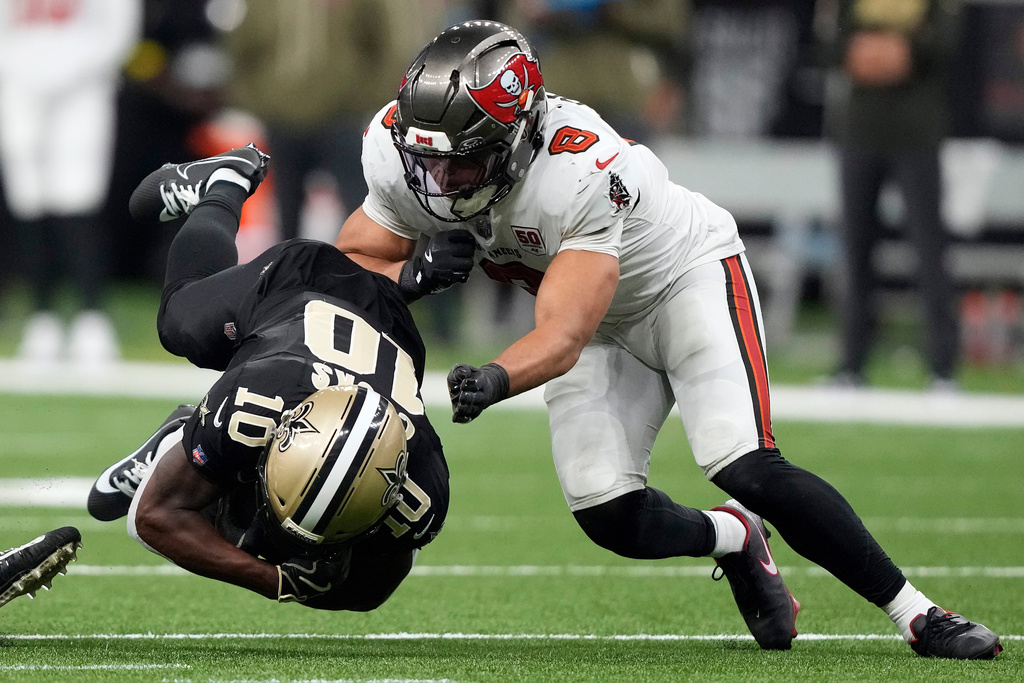 Tampa Bay Buccaneers linebacker SirVocea Dennis (8) takes down New Orleans Saints wide receiver Brandin Cooks (10) during the second half of an NFL football game Sunday, Oct. 26, 2025, in New Orleans. (AP Photo/Gerald Herbert)