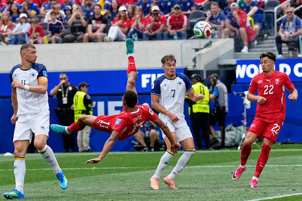 Switzerland's Dan Ndoye (11) attemps an overhead kick during the World Cup Group B soccer match between Switzerland and Bosnia in Inglewood, Calif, near Los Angeles, Thursday, June 18, 2026. (AP Photo/Gregory Bull)