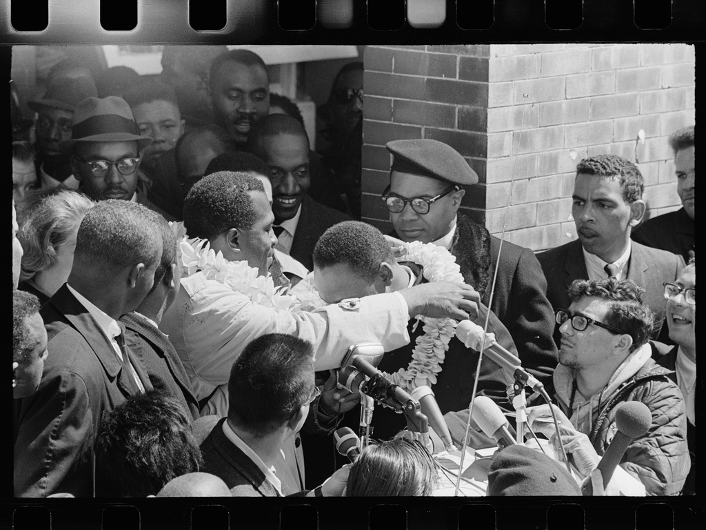 Charles Campbell, who traveled to Alabama for the march from Selma to Montgomery, placing a lei on Dr. Martin Luther King, Jr. at Brown Chapel AME in Selma, Ala., March 21, 1965. (Matt Herron/Jeannine Herron/Dept. of Special Collections and University Archives, Stanford University Libraries via AP)