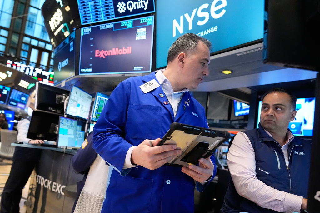 Christopher Lagana, left, and Dilip Patel work on the floor at the New York Stock Exchange in New York, Monday, March 30, 2026. (AP Photo/Seth Wenig)