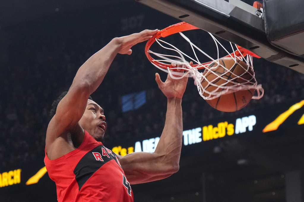 Toronto Raptors' Scottie Barnes (4) scores during first half NBA basketball action against the Dallas Mavericks, in Toronto on Sunday, March 8, 2026. (Chris Young/The Canadian Press via AP)