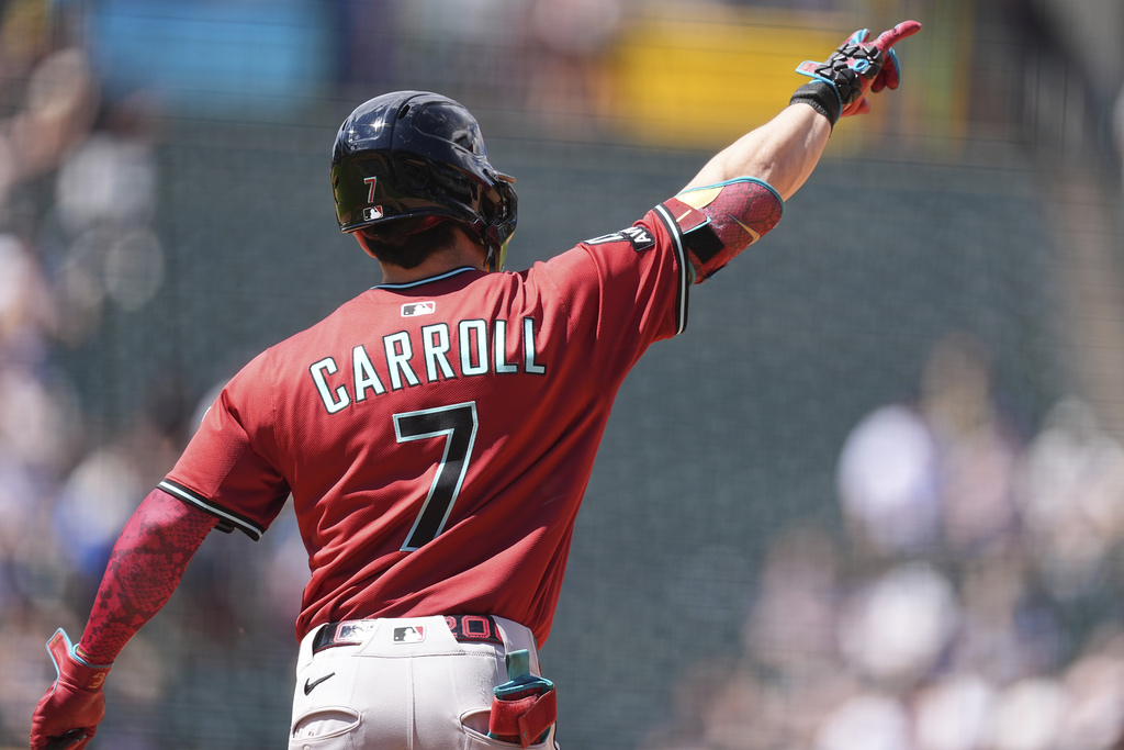 Arizona Diamondbacks' Corbin Carroll gestures to the bullpen as he circles the bases after hitting a solo home run off Colorado Rockies relief pitcher Luis Peralta in the sixth inning of a baseball game Sunday, Aug. 17, 2025, in Denver. (AP Photo/David Zalubowski)