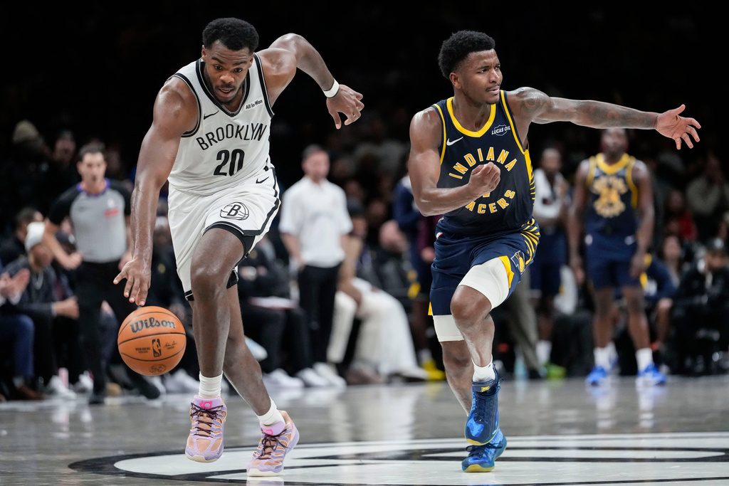 Brooklyn Nets center Day'ron Sharpe (20) drives past Indiana Pacers guard Kam Jones during the second half of an NBA basketball game, Wednesday, Feb. 11, 2026, in New York. (AP Photo/Yuki Iwamura)