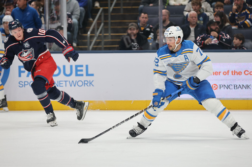 St. Louis Blues defenseman Justin Faulk, right, controls the puck in front of Columbus Blue Jackets forward Dmitri Voronkov during the first period of an NHL hockey game in Columbus, Ohio, Saturday, Nov. 1, 2025. (AP Photo/Paul Vernon) St. Louis Blues defenseman Justin Faulk, right, controls the puck in front of Columbus Blue Jackets forward Dmitri Voronkov during the first period of an NHL hockey game in Columbus, Ohio, Saturday, Nov. 1, 2025. (AP Photo/Paul Vernon)
