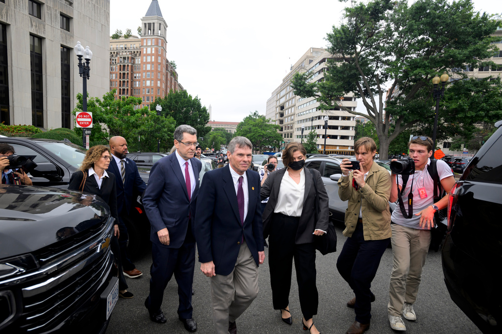 Former Olympic canoeist David Hearn, center, and his attorney Norman Eisen, left, walk to a car following a court appearance, where he pleaded not guilty to allegedly damaging the Lincoln Memorial Reflecting Pool, Thursday, July 9, 2026, in Washington. (AP Photo/Rod Lamkey, Jr.)