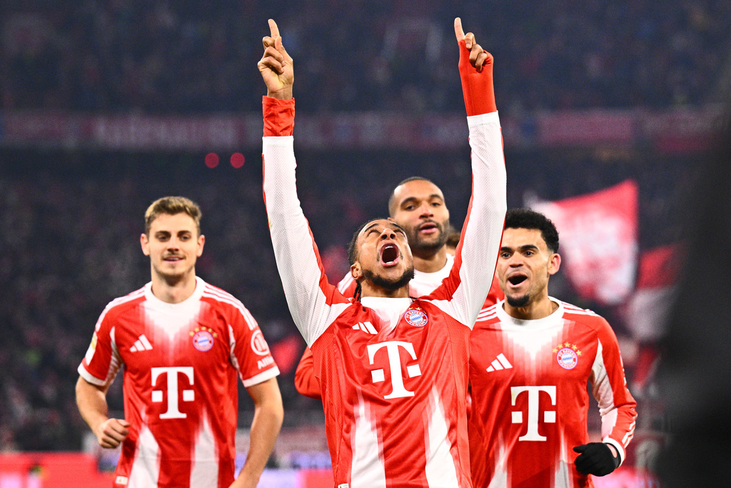 Munich's Michael Olise celebrates scoring during the Bundesliga soccer match between Bayern Munich and VfL Wolfsburg in Munich, Germany, Sunday Jan. 11, 2026. (Tom Weller/dpa via AP)