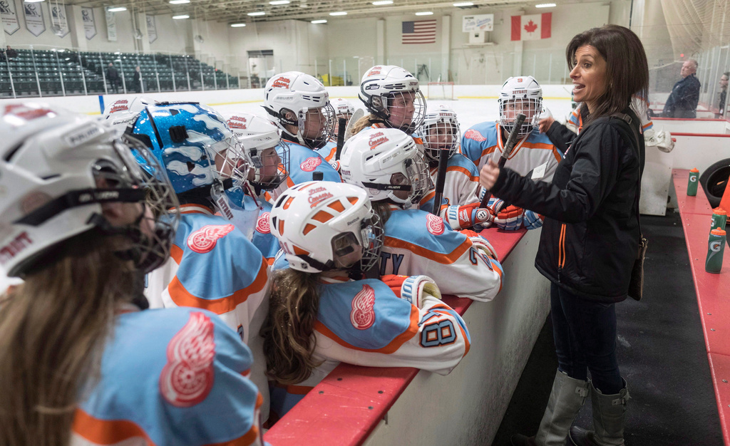 FILE - Former professional goaltender Manon Rheaume gives instructions to her players while behind the bench coaching the Little Caesars hockey team, Wednesday, Nov. 2, 2016, in Detroit. (Paul Chiasson/The Canadian Press via AP)