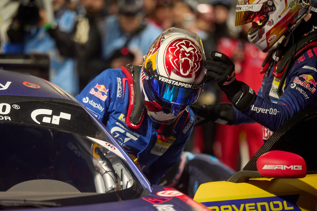 Daniel Juncadella, right, helps his teammate Max Verstappen to get into the car during a pit stop the Nurburgring 24-hour auto race in Nurburg, Germany, Sunday, May 17, 2026. (Thomas Frey/dpa via AP)