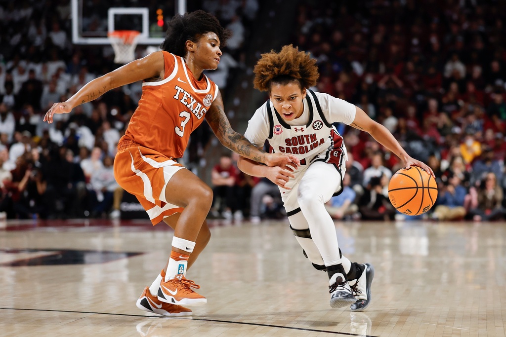 South Carolina guard Maddy McDaniel, right, drives against Texas guard Rori Harmon (3) during the first half of an NCAA college basketball game in Columbia, S.C., Thursday, Jan. 15, 2026. (AP Photo/Nell Redmond)