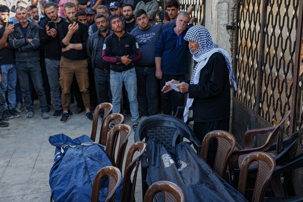 A man speaks during the funeral of two women and a man killed when gunmen on motorcycles fired on a van near the Druze village of Kafr Maris, Syria's Idlib province, Wednesday, Oct. 22, 2025. (AP Photo/Omar Albam)