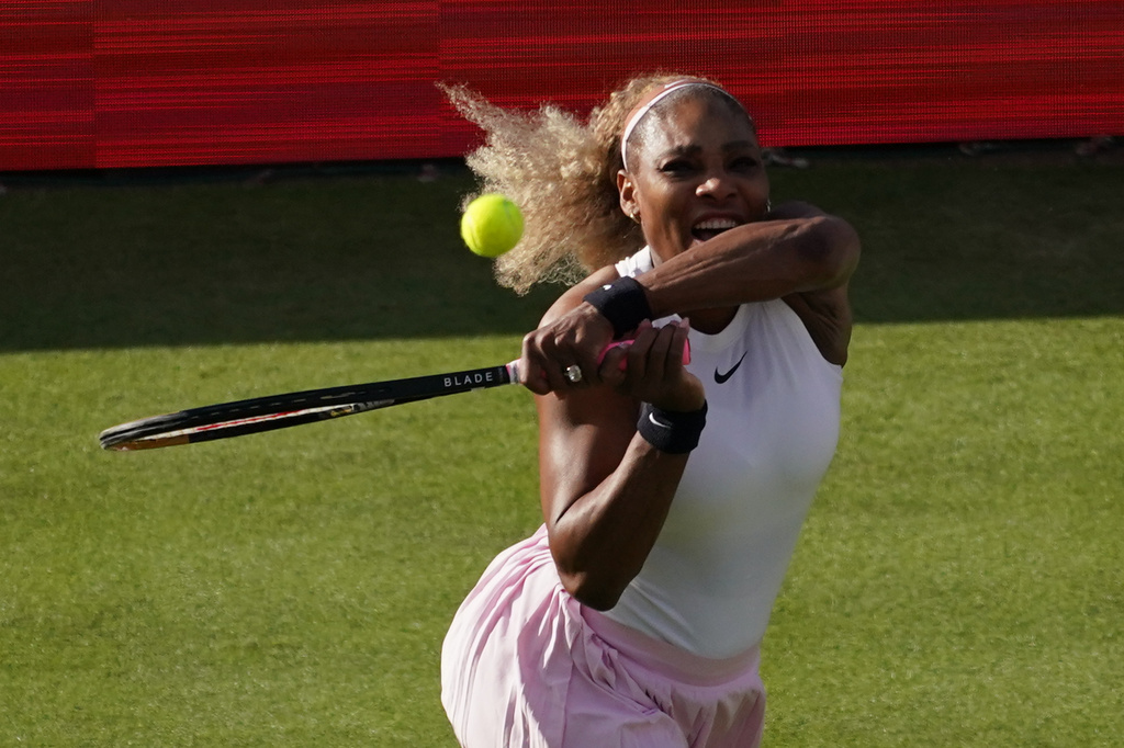 Serena Williams of the United States, hits a return as she and playing partner Victoria Mboko of Canada play against Nicole Melichar-Martinez of Canada and Erin Routliffe of New Zealand during their first round doubles match at the Queen's Club tennis championships in London, Tuesday, June 9, 2026. (AP Photo/Alberto Pezzali)