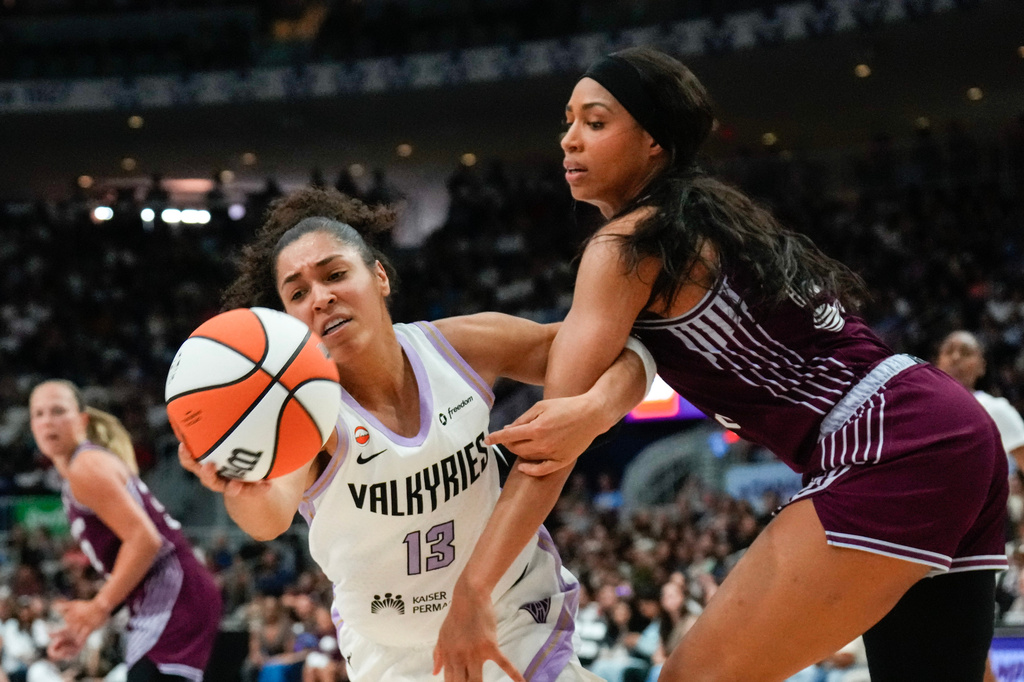 Golden State Valkyries forward Janelle Salaun (13) grabs a loose ball in front of Toronto Tempo forward Isabelle Harrison during the second half of a WNBA basketball game in Toronto on Wednesday, July 8, 2026. (Chris Young/The Canadian Press via AP)