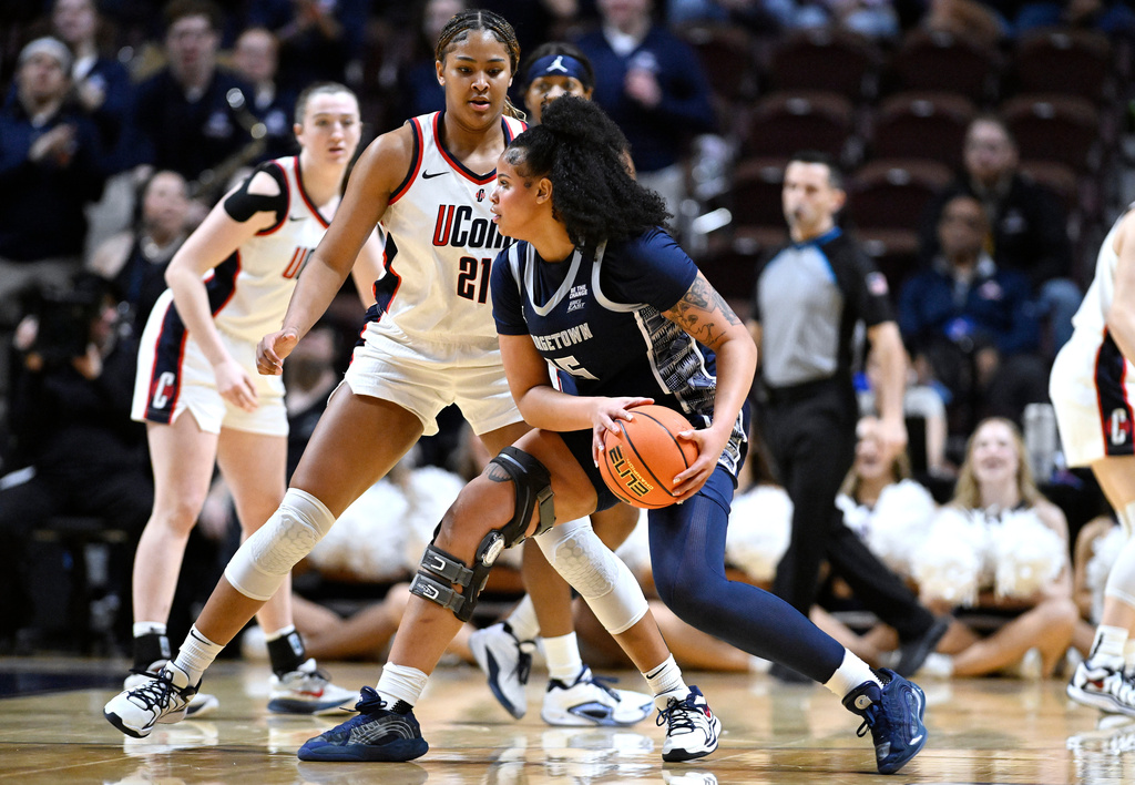 Georgetown forward Brianna Scott (15) is guarded by UConn forward Sarah Strong (21) during first half of an NCAA college basketball game in the quarterfinals of the Big East tournament, Saturday, March 7, 2026, in Uncasville, Conn. (AP Photo/Jessica Hill)