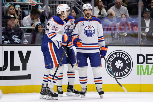 Edmonton Oilers defenseman Evan Bouchard (2), right, is congratulated by right wing David Tomasek (86) after scoring against the Seattle Kraken in the second period of an NHL hockey game Saturday, Oct. 25, 2025, in Seattle. (AP Photo/John Froschauer) Edmonton Oilers defenseman Evan Bouchard (2), right, is congratulated by right wing David Tomasek (86) after scoring against the Seattle Kraken in the second period of an NHL hockey game Saturday, Oct. 25, 2025, in Seattle. (AP Photo/John Froschauer)