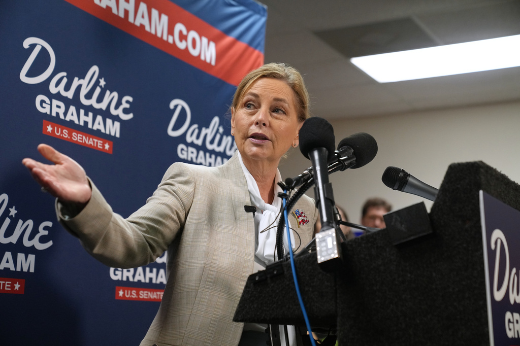 Sen. Darline Graham, R-S.C., gestures to Gov. Henry McMaster, R-S.C., at a news conference for her campaign a day ahead of the special GOP Senate runoff to replace her brother, the late Sen. Lindsey Graham, R-S.C., Monday, Aug. 24, 2026, in Columbia, S.C. (AP Photo/Meg Kinnard)