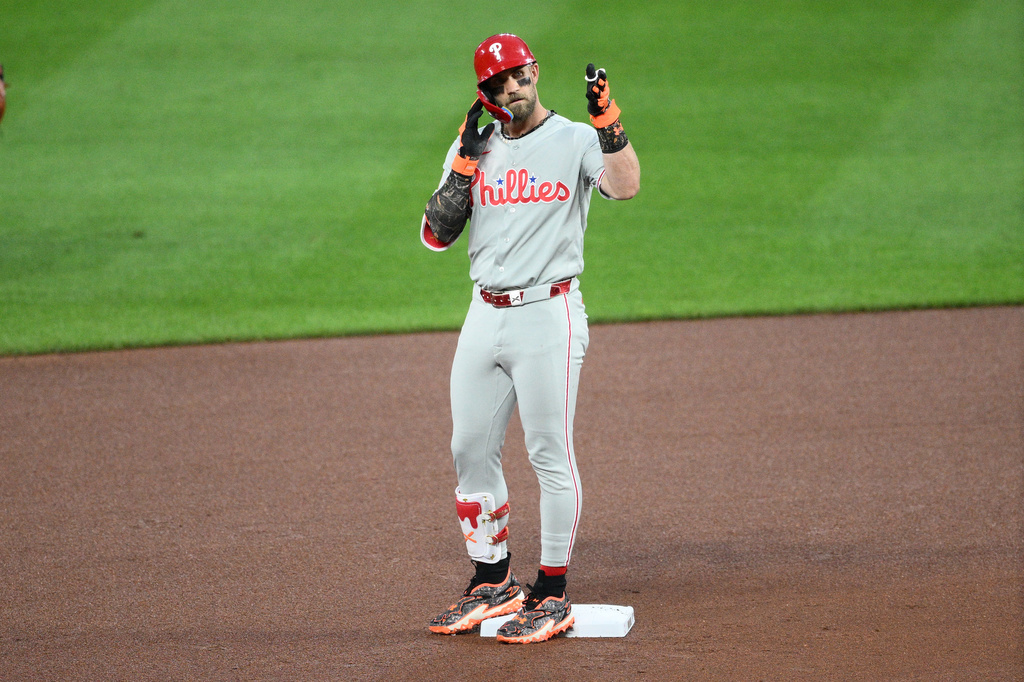 Philadelphia Phillies' Bryce Harper gestures at second base after hitting a ground rule double during the fourth inning of a baseball game against the Baltimore Orioles, Saturday, Aug. 1, 2026, in Baltimore. (AP Photo/Nick Wass)