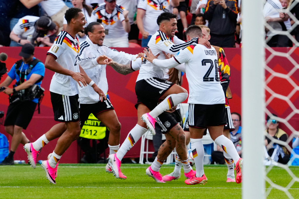 Germany's Deniz Undav (26) is mobbed by teammates after scoring their second goal during the World Cup Group E soccer match between Germany and Ivory Coast in Toronto, Saturday, June 20, 2026. (Frank Gunn/The Canadian Press via AP)
