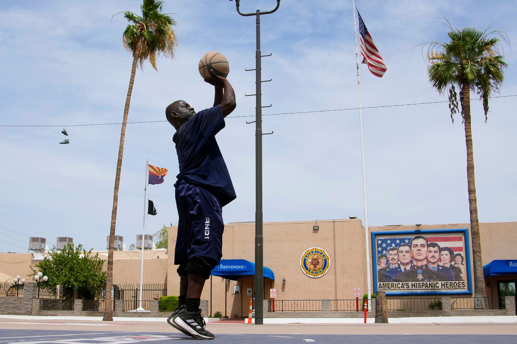 Tony McNaire plays basketball in front of an American Legion Post, May 19, 2026, in Phoenix. (AP Photo/Ross D. Franklin)