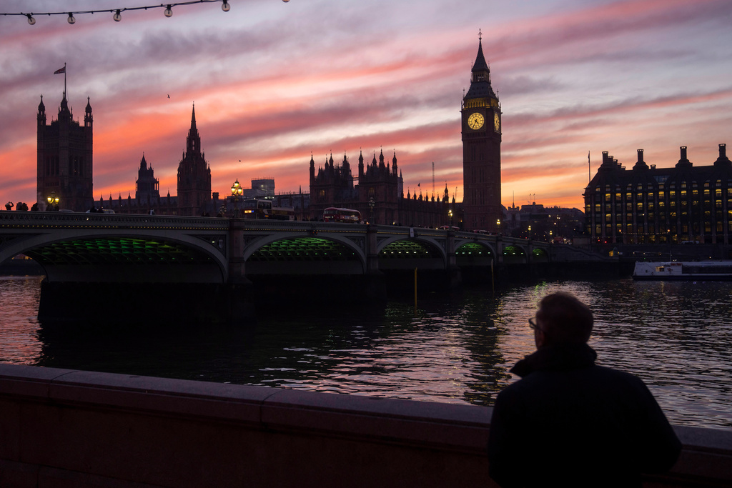FILE - A man walks along the south bank of the River Thames backdropped by the Elizabeth Tower, known as Big Ben, of the Houses of Parliament, in London, Tuesday, Jan. 17, 2023. (AP Photo/Kin Cheung, File)