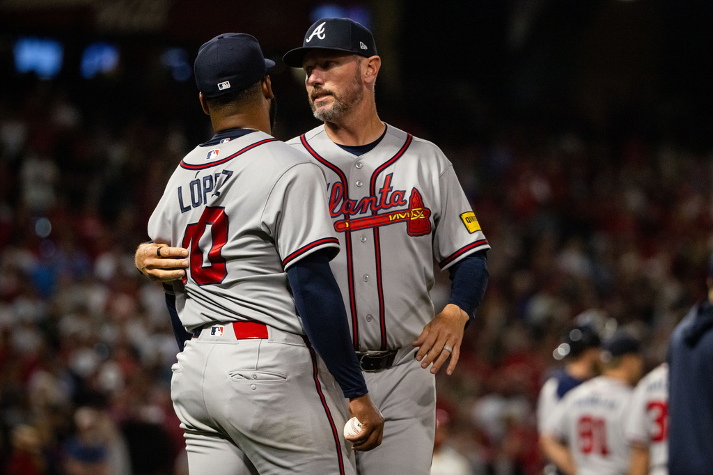 Atlanta Braves pitcher Reynaldo López (40) is held back after a fight broke out during the fifth inning of a baseball game between the Los Angeles Angels and the Atlanta Braves, Tuesday, April 7, 2026, in Anaheim, Calif. (AP Photo/Ethan Swope)