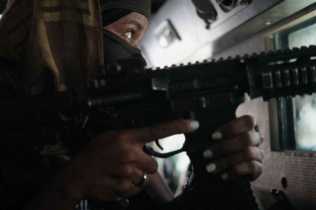 A police officer in an armored vehicle patrols a gang-controlled area of Port-au-Prince, Haiti, Monday, Jan. 19, 2026. (AP Photo/Odelyn Joseph)