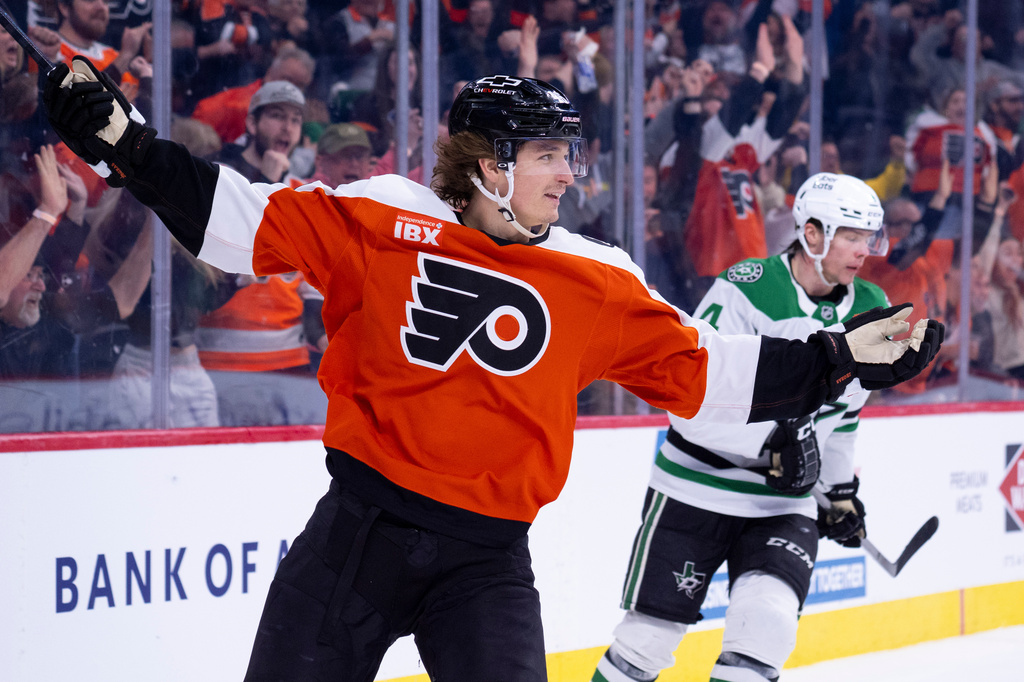 Philadelphia Flyers center Trevor Zegras, left, reacts to his game winning goal as Dallas Stars defenseman Miro Heiskanen, right, looks on during overtime of an NHL hockey game, Sunday, March 29, 2026, in Philadelphia. (AP Photo/Chris Szagola)