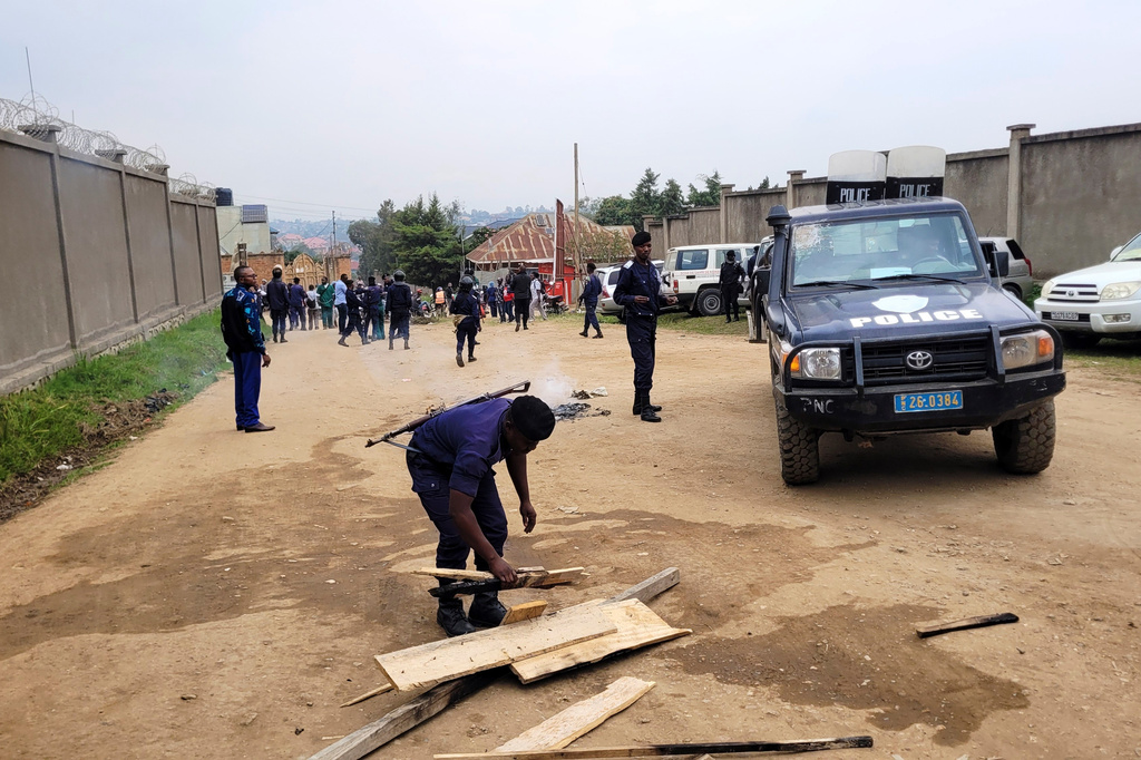 A police officer removes rubble as health workers involved in Congo's Ebola response go on strike to protest over payment issues in Bunia, Congo, Wednesday, July 15, 2026. (AP Photo/Constant Same Bagalwa)