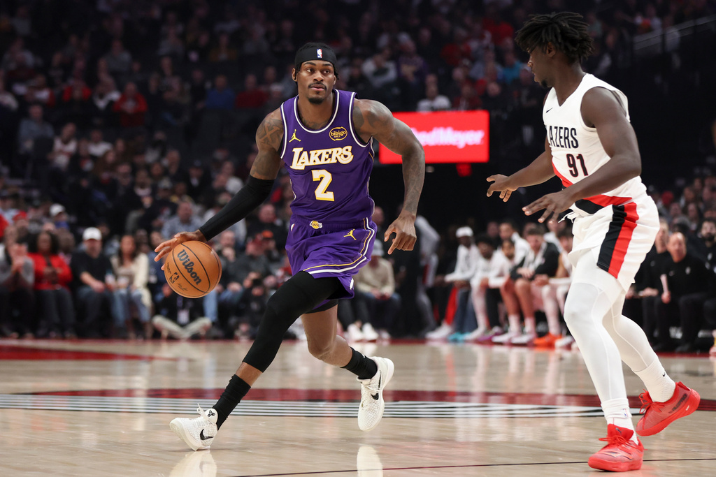 Los Angeles Lakers forward Jarred Vanderbilt (2) brings the ball upcourt as Portland Trail Blazers guard Sidy Cissoko (91) defends during the first half of an NBA basketball game Monday, Nov. 3, 2025, in Portland, Ore. (AP Photo/Amanda Loman)