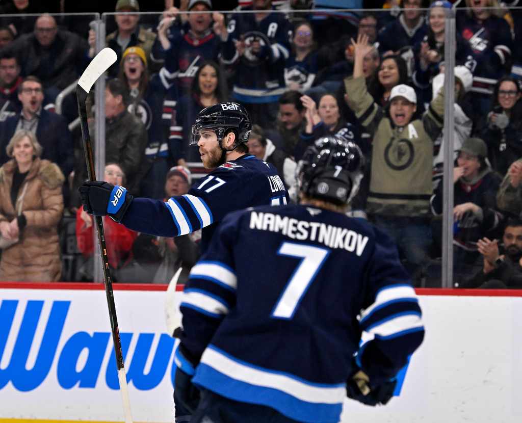 Winnipeg Jets' Adam Lowry (17) celebrates his goal against the New York Islanders during the second period of their NHL hockey game in Winnipeg, Manitoba, Tuesday, Jan. 13, 2026. (Fred Greenslade/The Canadian Press via AP)