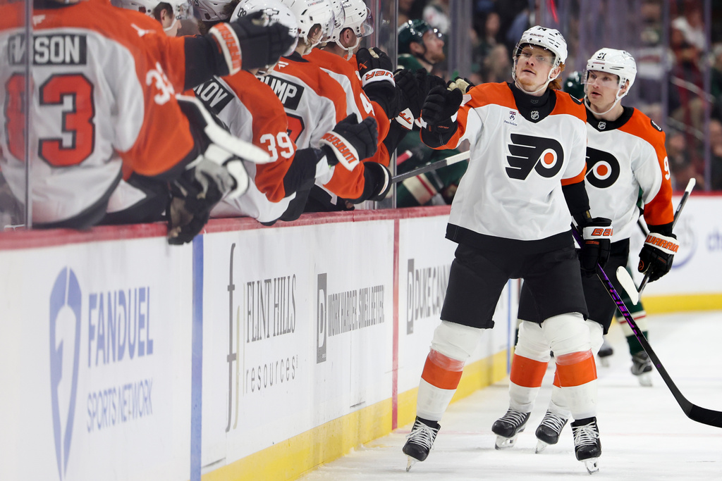 Philadelphia Flyers right wing Owen Tippett, second from right, celebrates at the bench after scoring a goal during the third period of an NHL hockey game against the Minnesota Wild, Thursday, March 12, 2026, in St. Paul, Minn. (AP Photo/Ellen Schmidt)
