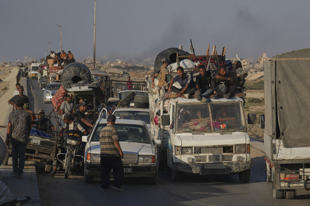 Displaced Palestinians fleeing northern Gaza Strip move with their belongings along the Sea Road, near Wadi Gaza, Saturday, Aug. 30, 2025. (AP Photo/Abdel Kareem Hana)