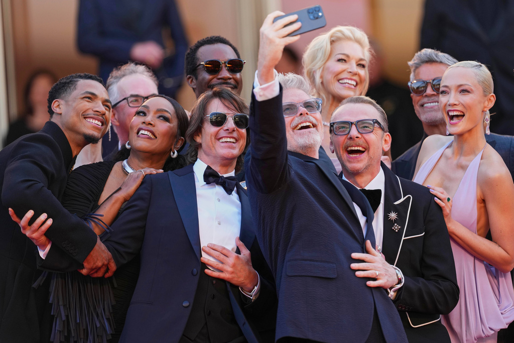 Greg Tarzan Davis, from left, editor Eddie Hamilton, Angela Bassett, Tramell Tillman, Tom Cruise, director Christopher McQuarrie, Hannah Waddingham, Simon Pegg, Esai Morales, and Pom Klementieff pose for a group selfie upon their arrival to the premiere of the film 'Mission: Impossible - The Final Reckoning' at the 78th international film festival, Cannes, southern France, May 14, 2025. (Photo by Scott A Garfitt/Invision/AP File)