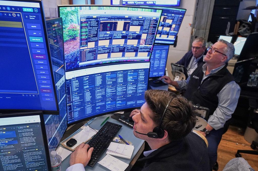 A trio of traders work on the floor of the New York Stock Exchange, Wednesday, June 3, 2026. (AP Photo/Richard Drew)