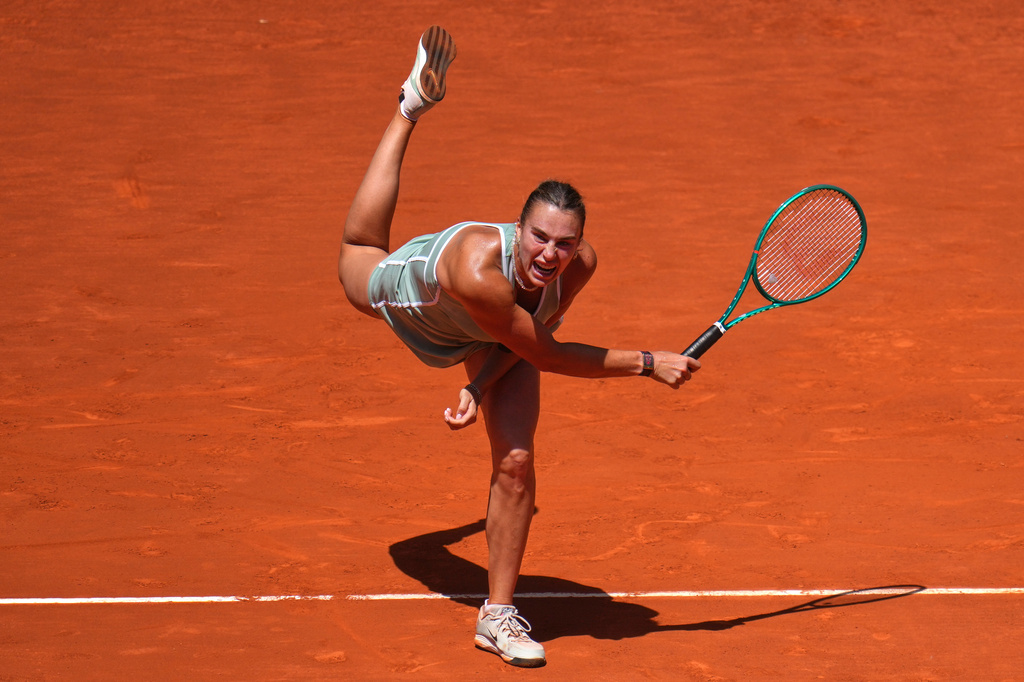 Aryna Sabalenka of Belarus serves the ball to Naomi Osaka of Japan during the Madrid Open tennis tournament in Madrid, Monday, April 27, 2026. (AP Photo/Manu Fernandez)