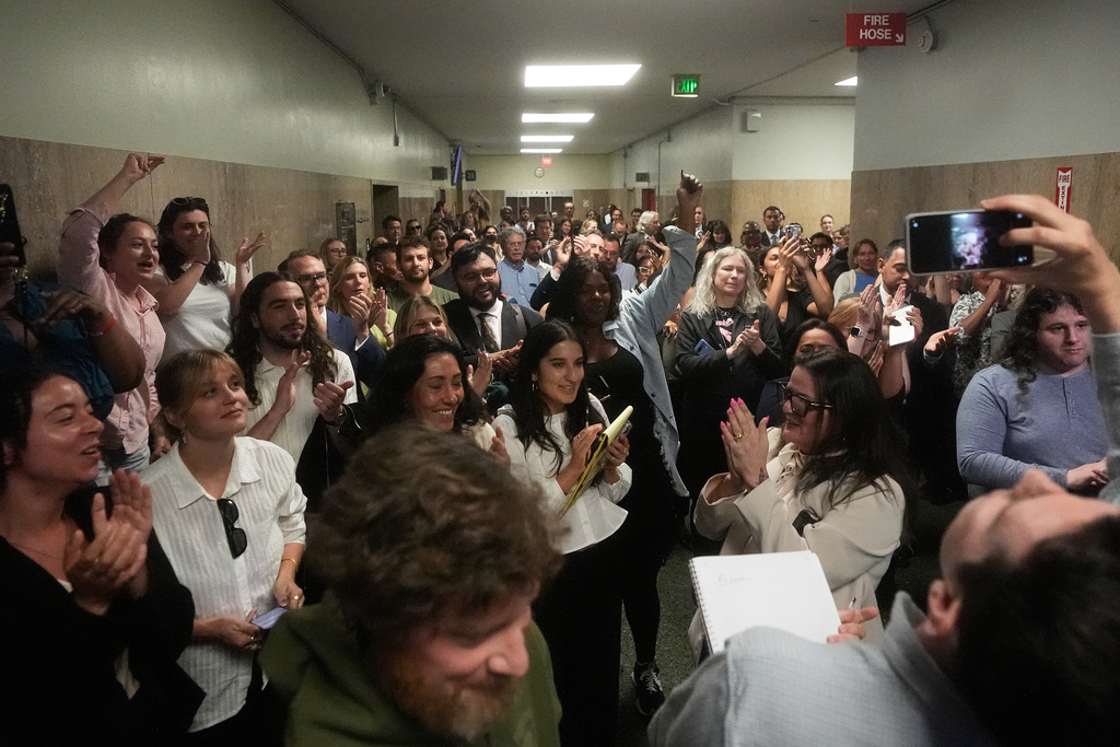 Supporters of San Francisco Public Defender Mano Raju cheer outside of a courtroom in San Francisco, Tuesday, March 24, 2026. (AP Photo/Jeff Chiu)