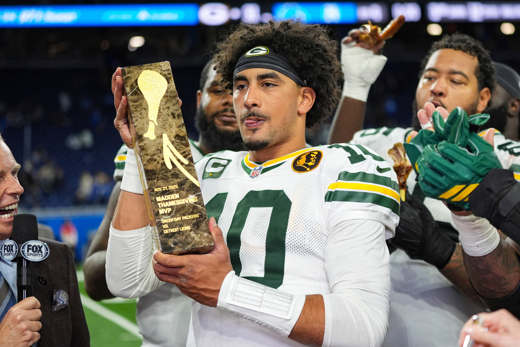 Green Bay Packers quarterback Jordan Love (10) holds the Madden Thanksgiving MVP trophy following an NFL football game against the Detroit Lions in Detroit, Thursday, Nov. 27, 2025. (AP Photo/Ryan Sun)