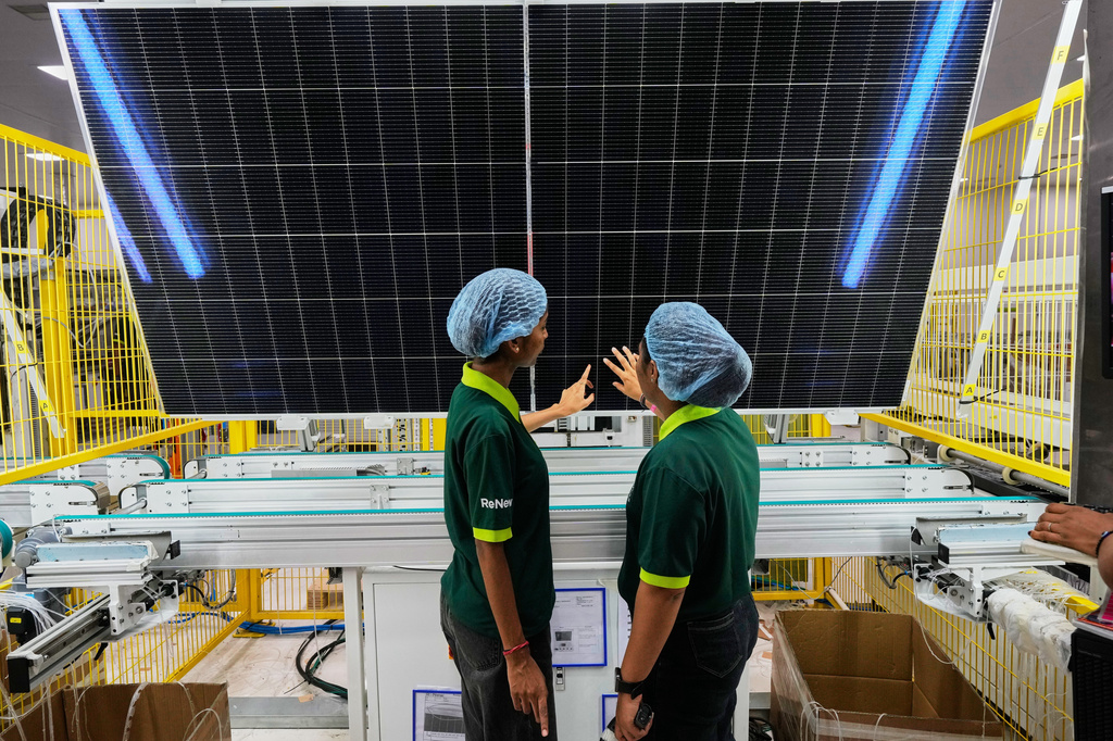 FILE - Workers check the quality of a solar panel at the production line up at the ReNew solar panels manufacturing plant on the outskirts of Jaipur, India, Aug. 21, 2025. (AP Photo/Manish Swarup, File)