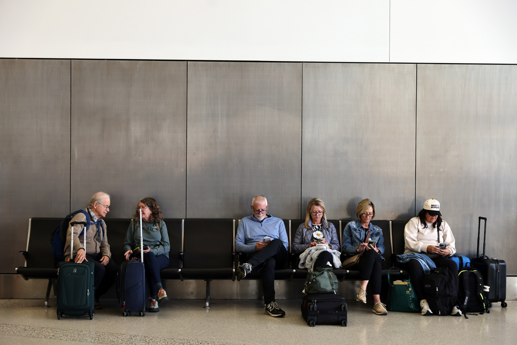 Travelers wait and check for their flights at San Francisco International Airport on Friday, Nov. 7, 2025. (Gabrielle Lurie /San Francisco Chronicle via AP)