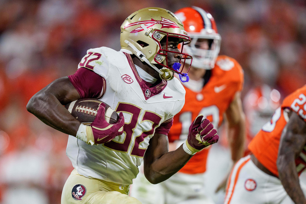 Florida State running back Ousmane Kromah (32) runs with the ball in the first half of an NCAA college football game against Clemson, Saturday, Nov. 8, 2025, in Clemson, S.C. (AP Photo/Jacob Kupferman)