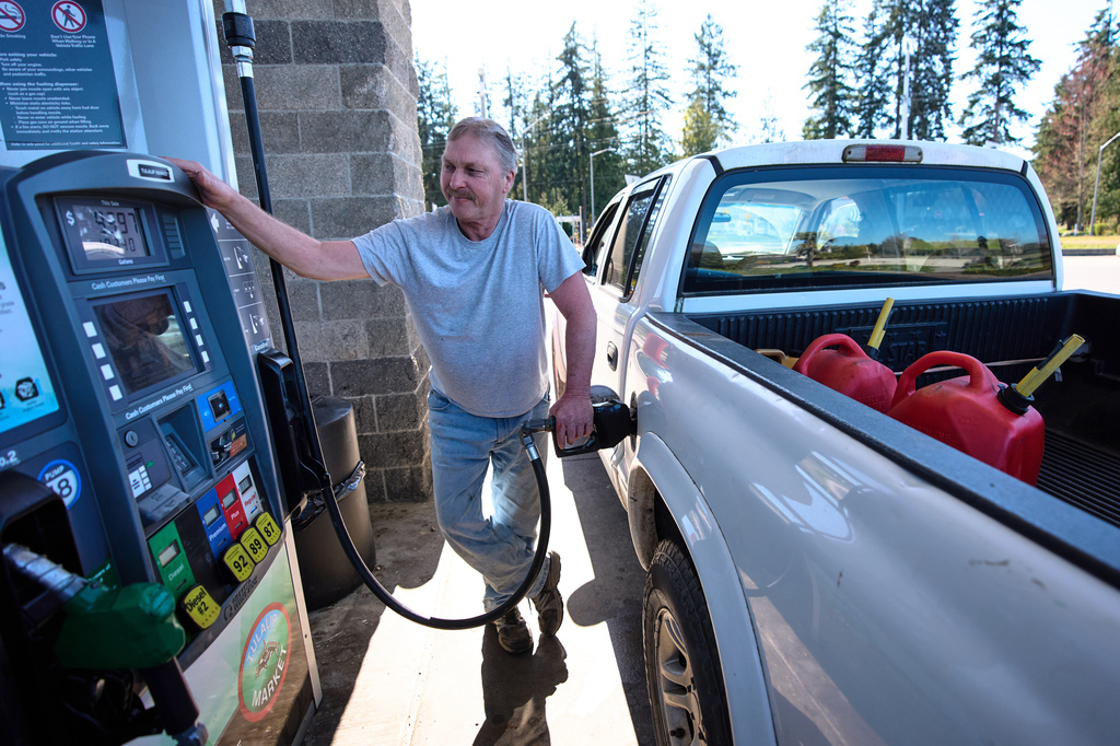 Darryl Smith fuels up his truck after putting extra gasoline into cans at the Tulalip Market gas station on the Tulalip Indian Reservation land, Wednesday, April 8, 2026, in Tulalip, Wash. (AP Photo/Lindsey Wasson)