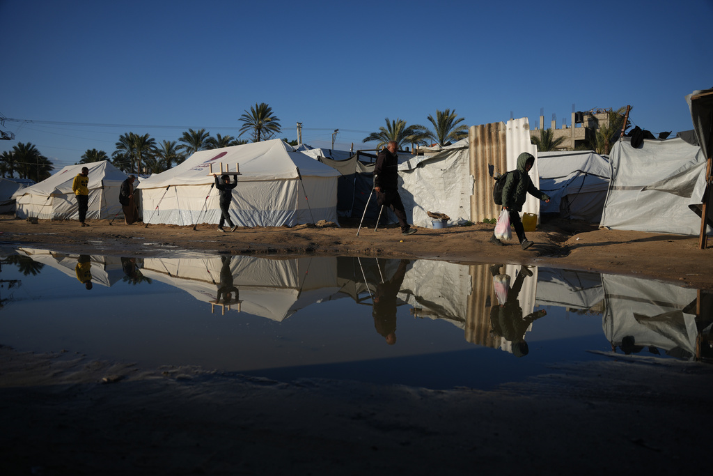 Sewage overflowed parts of a makeshift tent camp for displaced Palestinians in Deir al-Balah, Gaza Strip, Saturday, Jan. 17, 2026. (AP Photo/Abdel Kareem Hana)