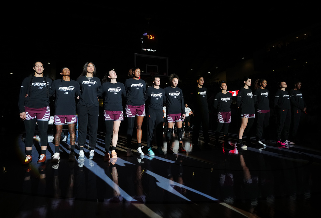 Toronto Tempo's Kia Nurse, left, and teammates stand for "O Canada" prior to WNBA basketball game action against the Washington Mystics in Toronto, Friday, May 8, 2026. (Nathan Denette/The Canadian Press via AP)