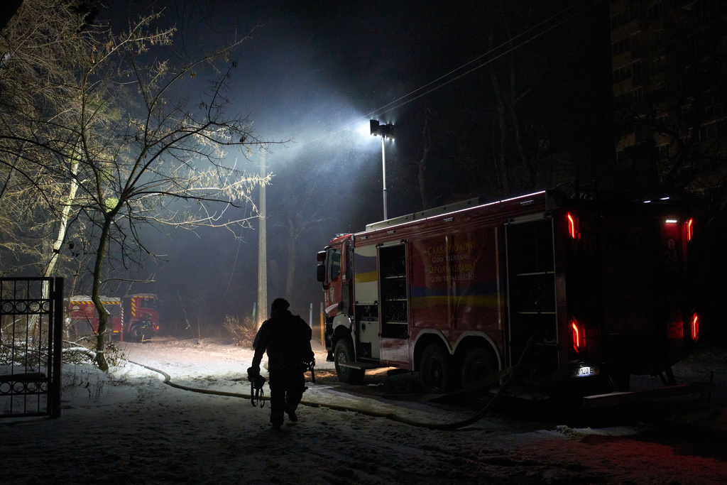 Rescue workers put out a fire at a residential building damaged by a Russian strike in Kyiv, Ukraine, Friday, Jan. 9, 2026. (AP Photo/Efrem Lukatsky)