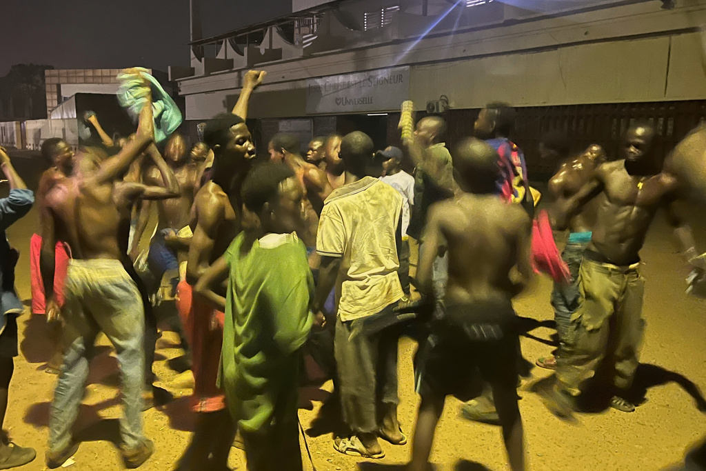 People celebrate on a street after President Faustin Archange Touadéra was declared the winner of the presidential election in Bangui, Central African Republic, Monday, Jan. 5, 2026. (AP Photo/Jean-Fernand Koena)