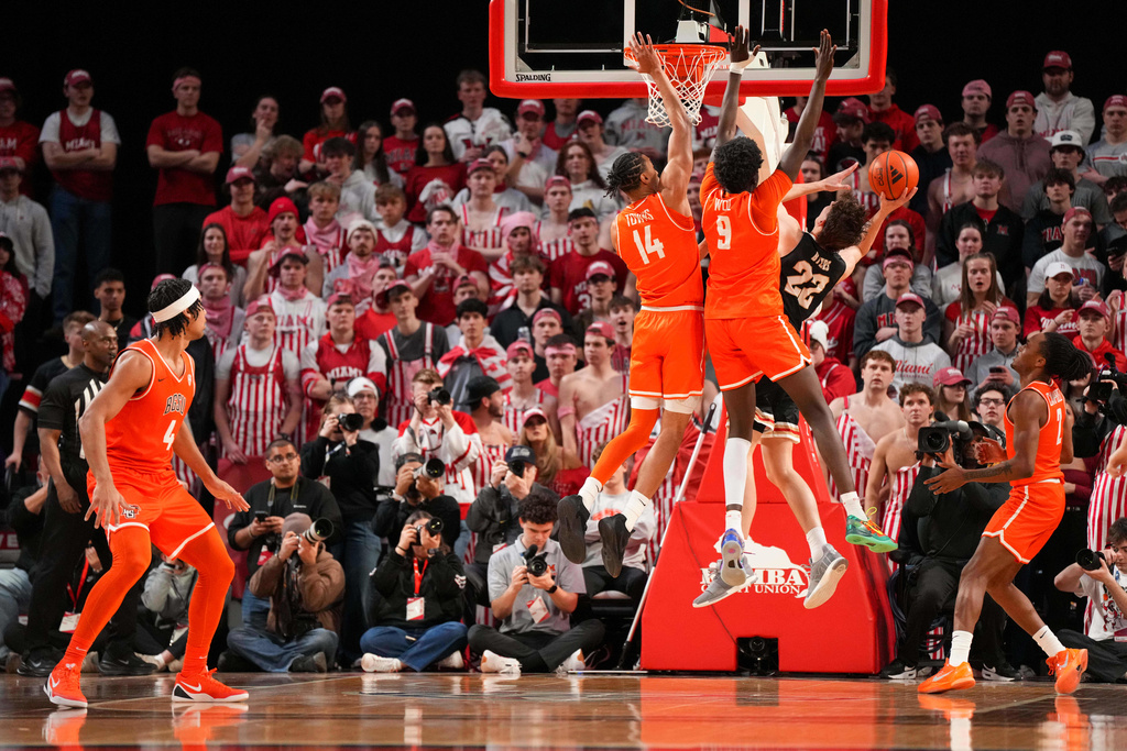 Miami (Ohio) forward Brant Byers (22) shoots against Bowling Green's Sam Towns (14) and Mayar Wol (9) during the first half of an NCAA college basketball game, Friday, Feb. 20, 2026, in Oxford, Ohio. (AP Photo/Jeff Dean)